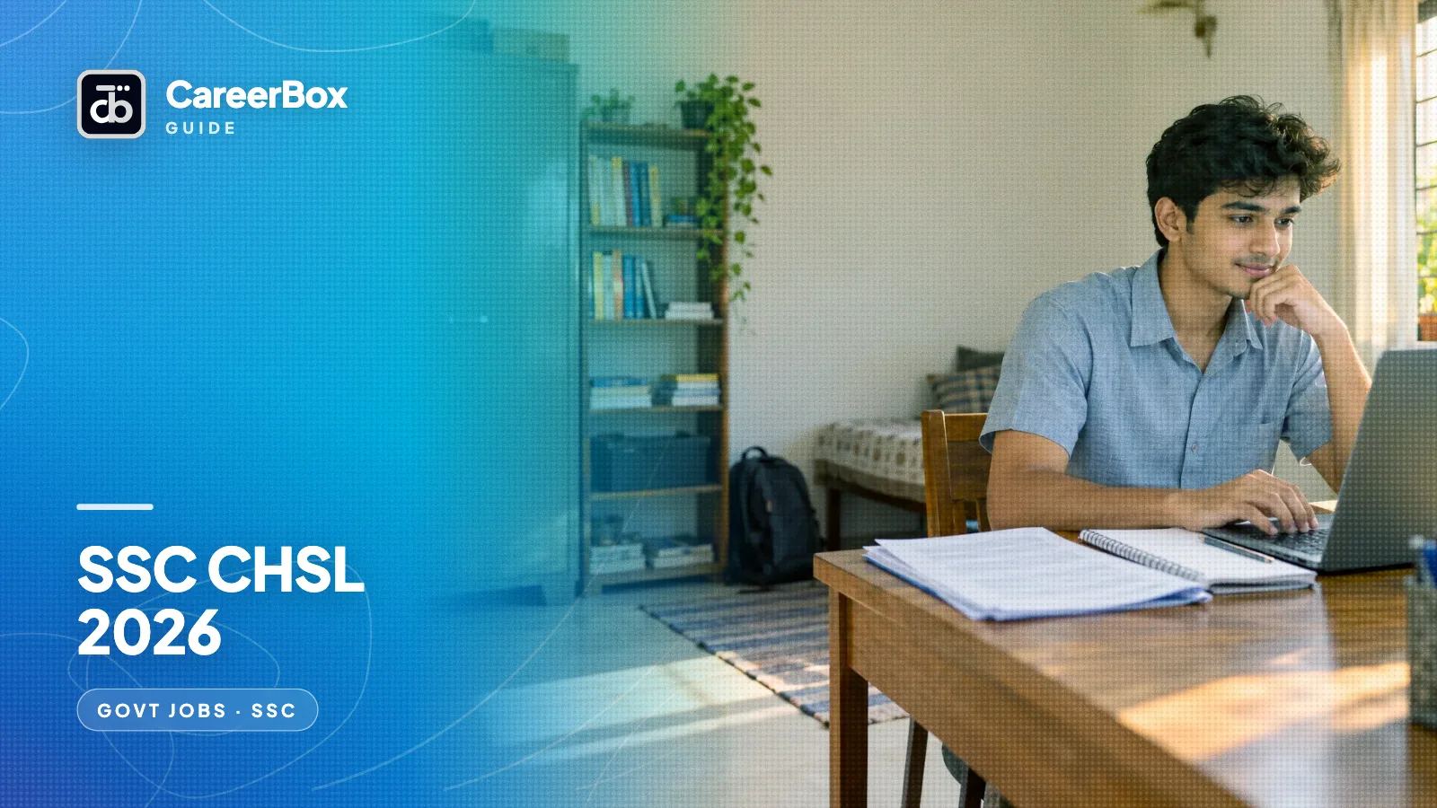 A young Indian man at a study desk at home preparing for the SSC CHSL exam on a laptop with a printed syllabus beside him